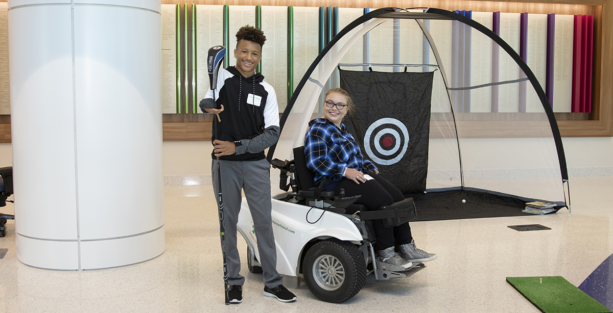 Patients, Korban and Jordan at an inclusive golfing event