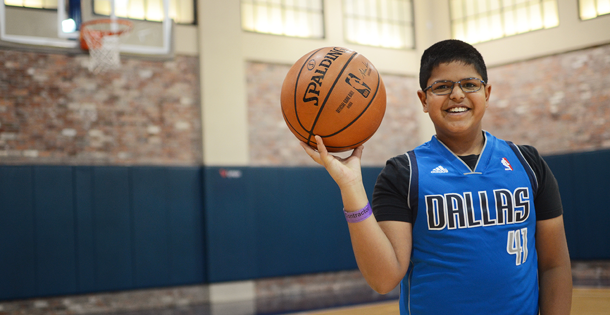 boy with basketball in gym